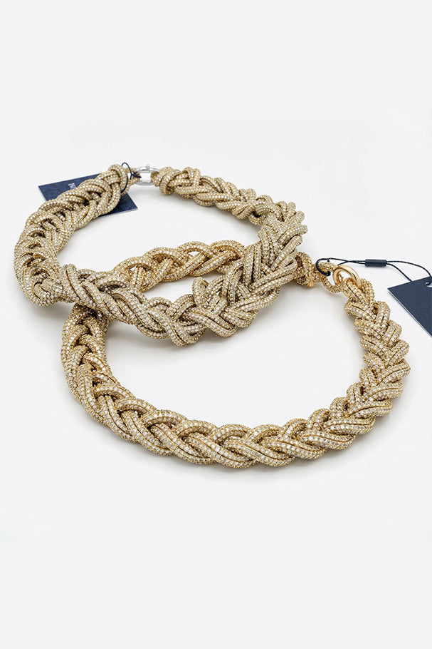 Gold braided necklace with a chunky design and sparkling embellishments.