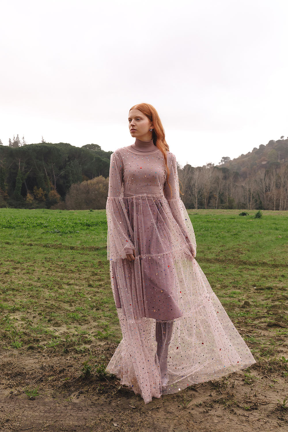 Pink tulle dress with multicolor embellishments worn by a model.