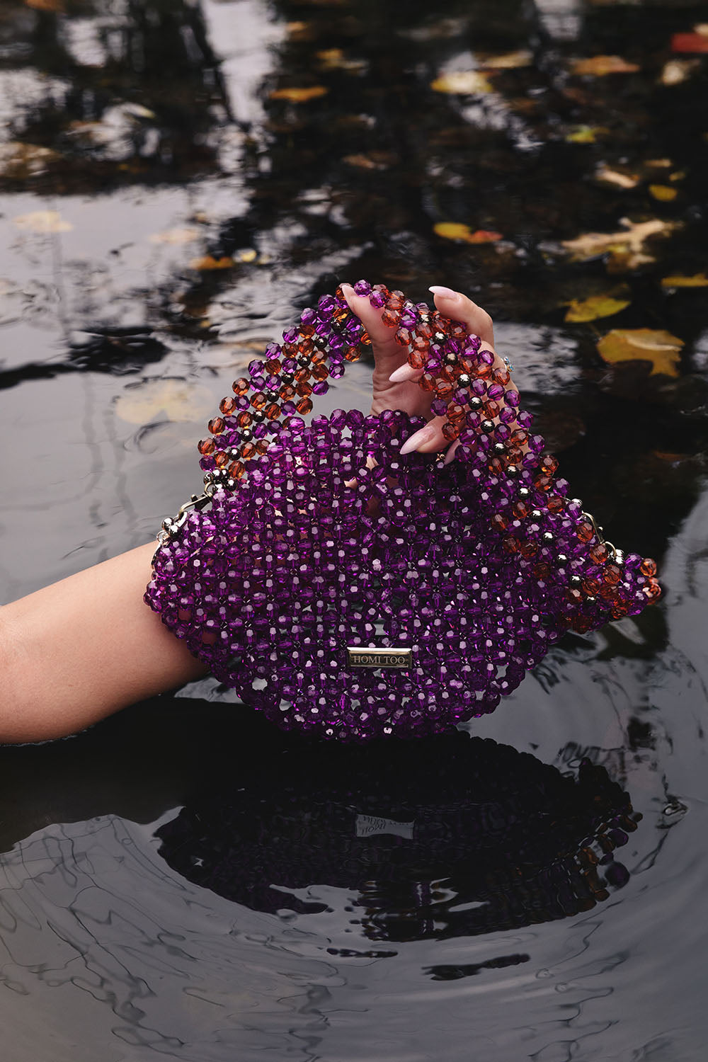 Purple beaded shoulder bag with multicolor beaded strap.
