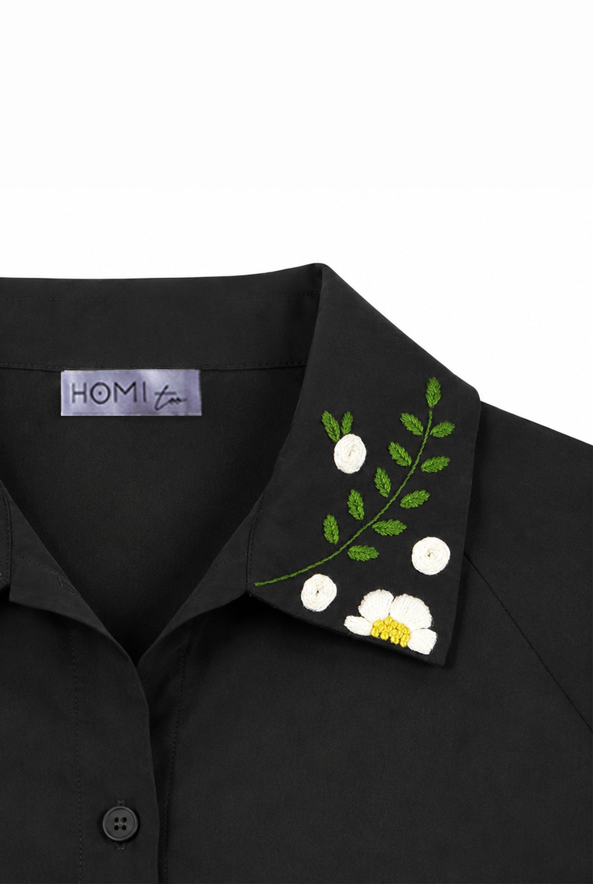 Detail of the floral embroidery on the collar of the black shirt.