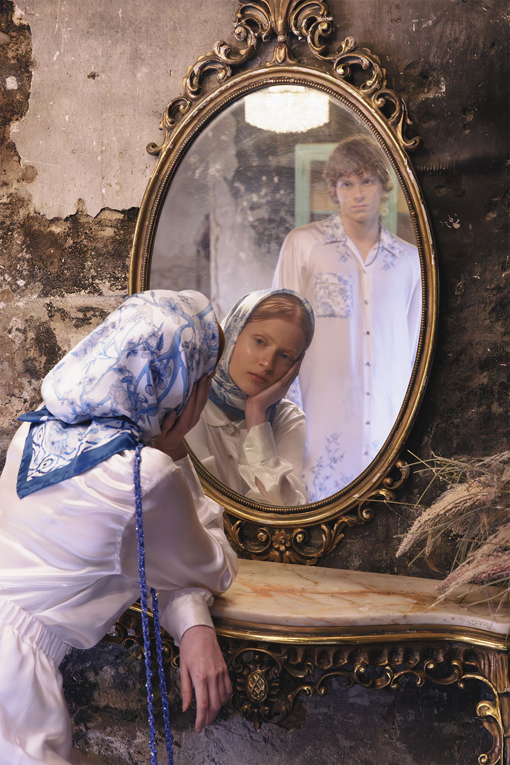 Blue and white floral silk scarf worn by a model.