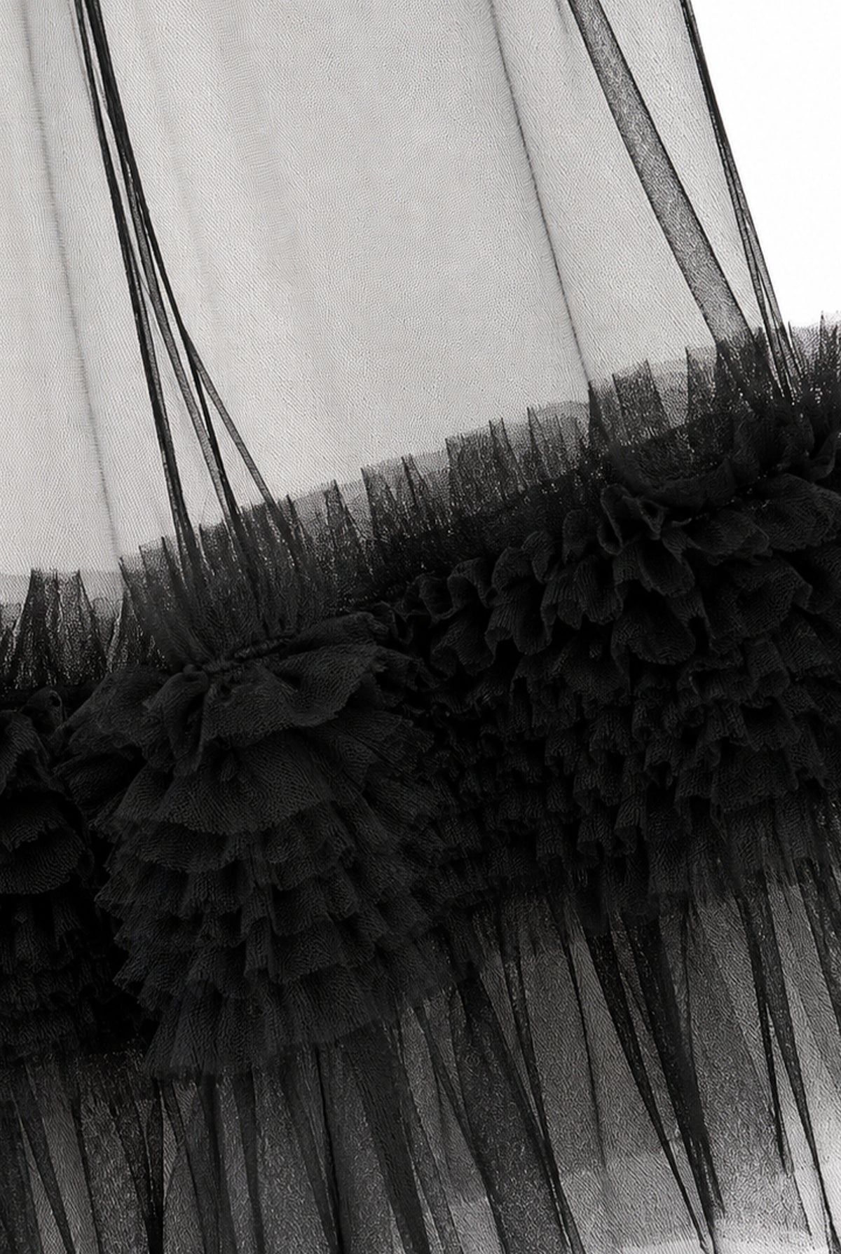Detail of the ruffled tulle on the black trousers.