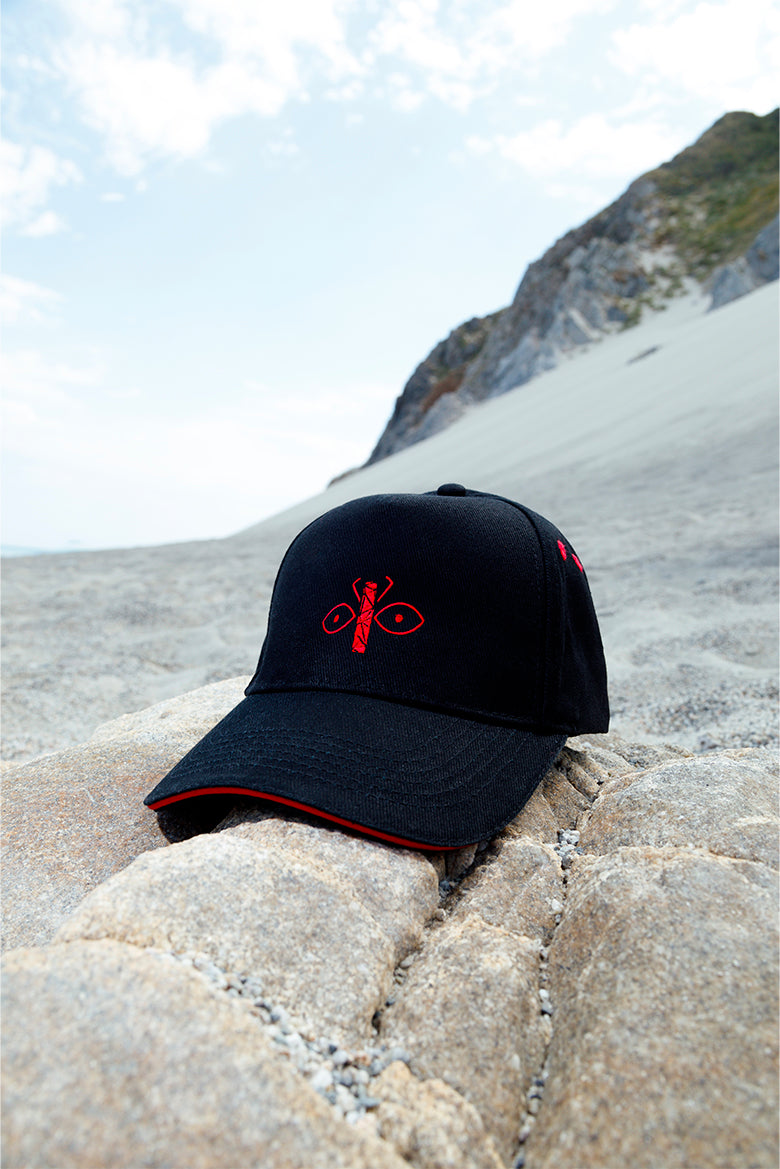 Black peaked cap with red embroidered logo on the front, versatile unisex accessory with modern style.