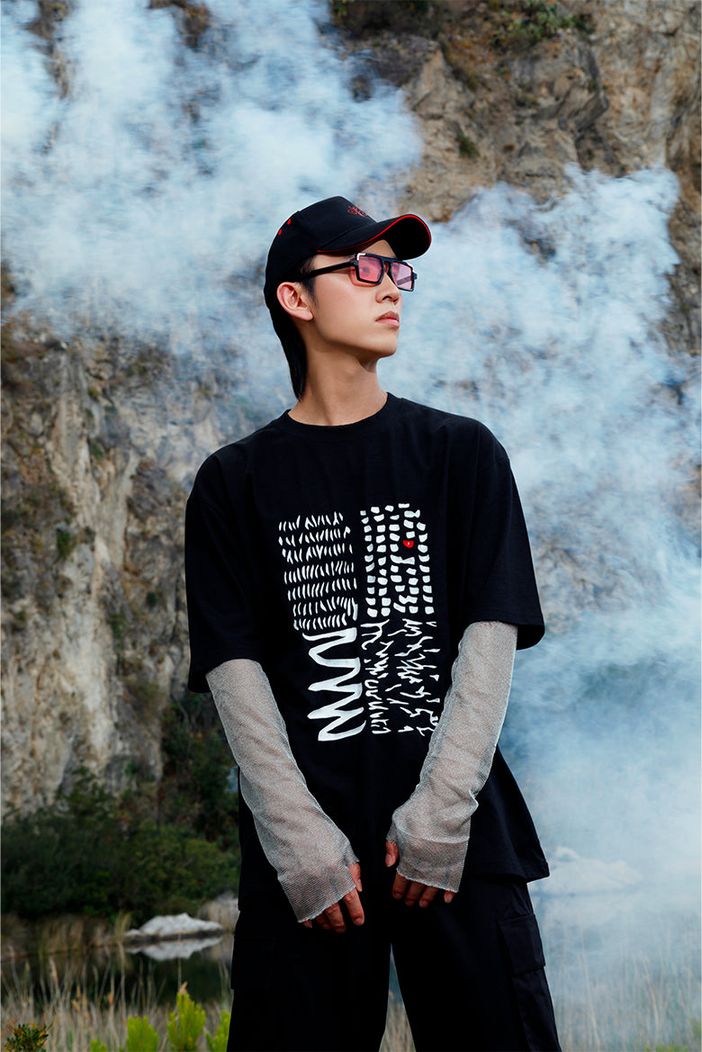Black peaked cap with red embroidered logo worn by a model, showcasing its versatile and fashionable design.