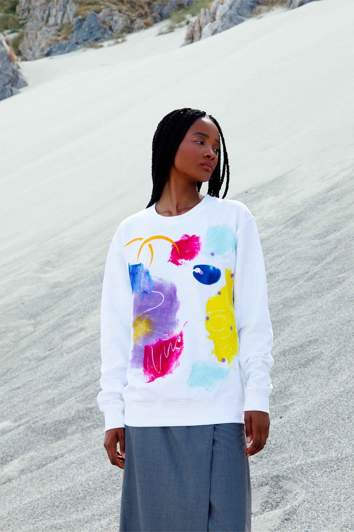 White oversized unisex sweatshirt worn by a model, featuring a colorful abstract relief silicone print on the front, made by hand, with soft and tactile texture.
