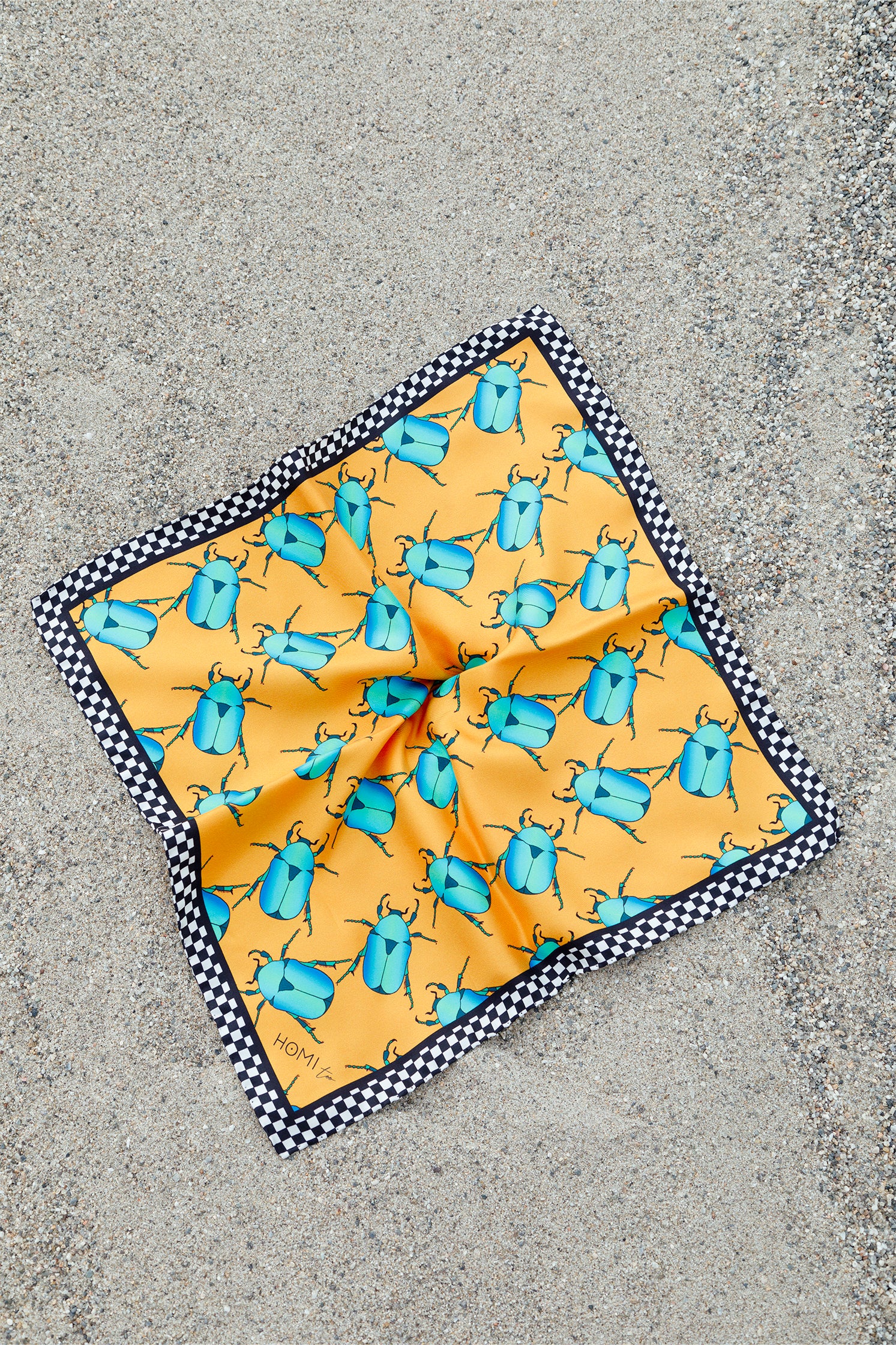 Silk scarf, 45x45 cm, featuring a striking graphic on an orange background with blue and black scarabs and a black and white checkered border, versatile accessory for styling around the neck, head, or as a bag detail.