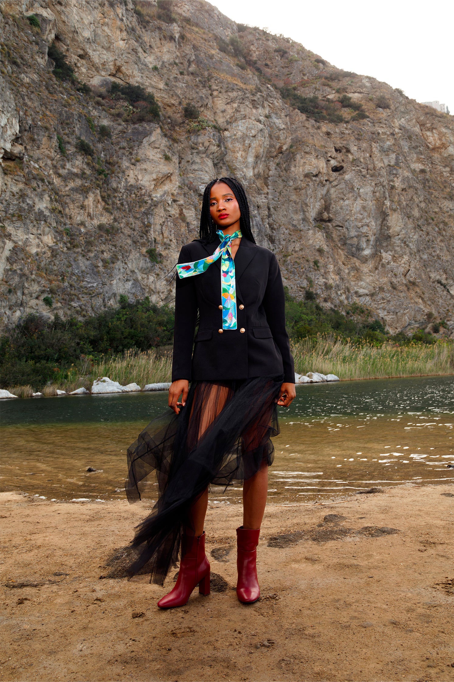 Silk scarf-tie worn around the neck by a model, showcasing the delicate stylized floral print and versatile styling.