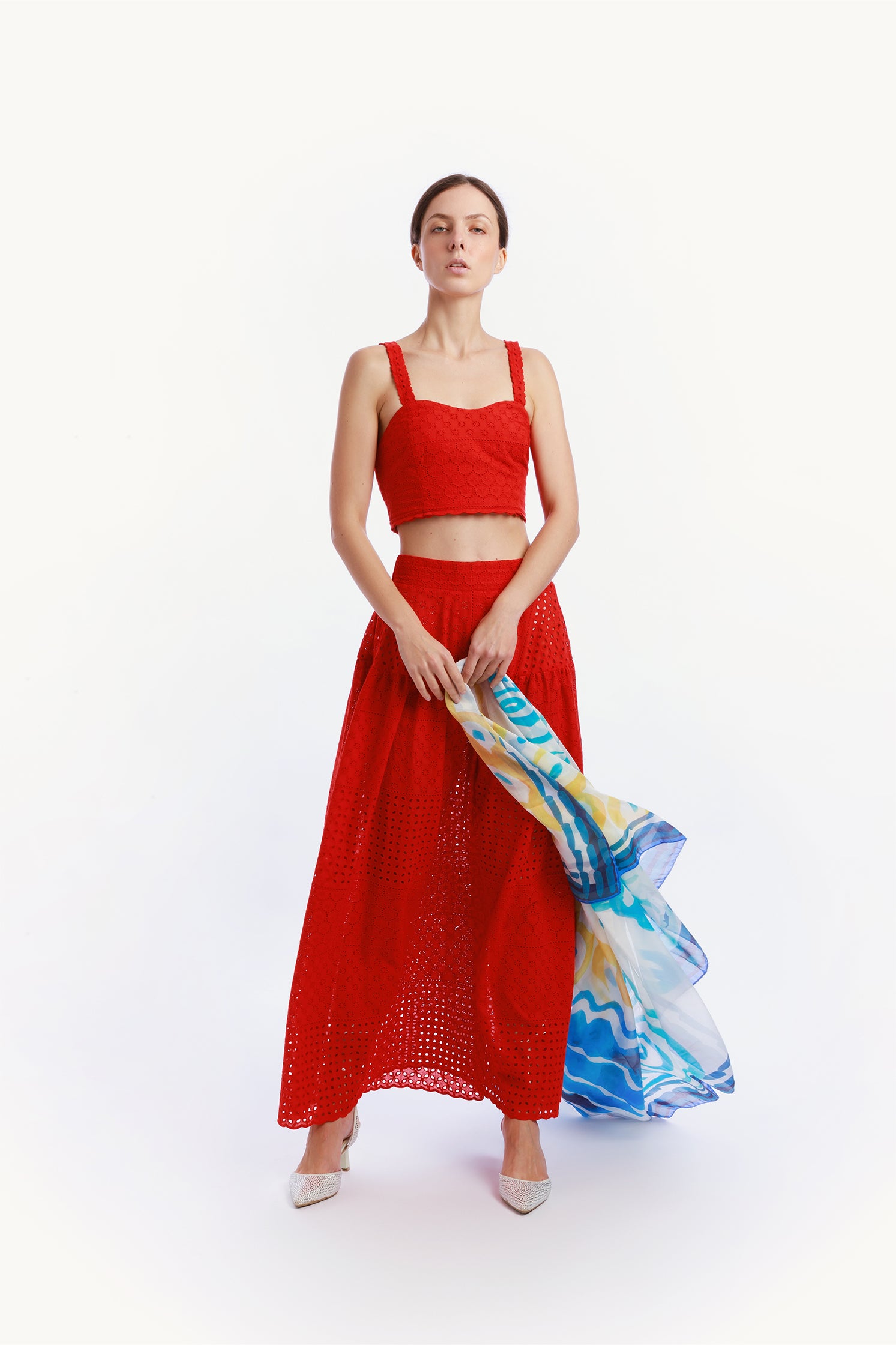 Front view of the red sangallo set worn by a model, featuring a long skirt with elastic waistband and a top with elasticated back, offering elegant and comfortable fit.