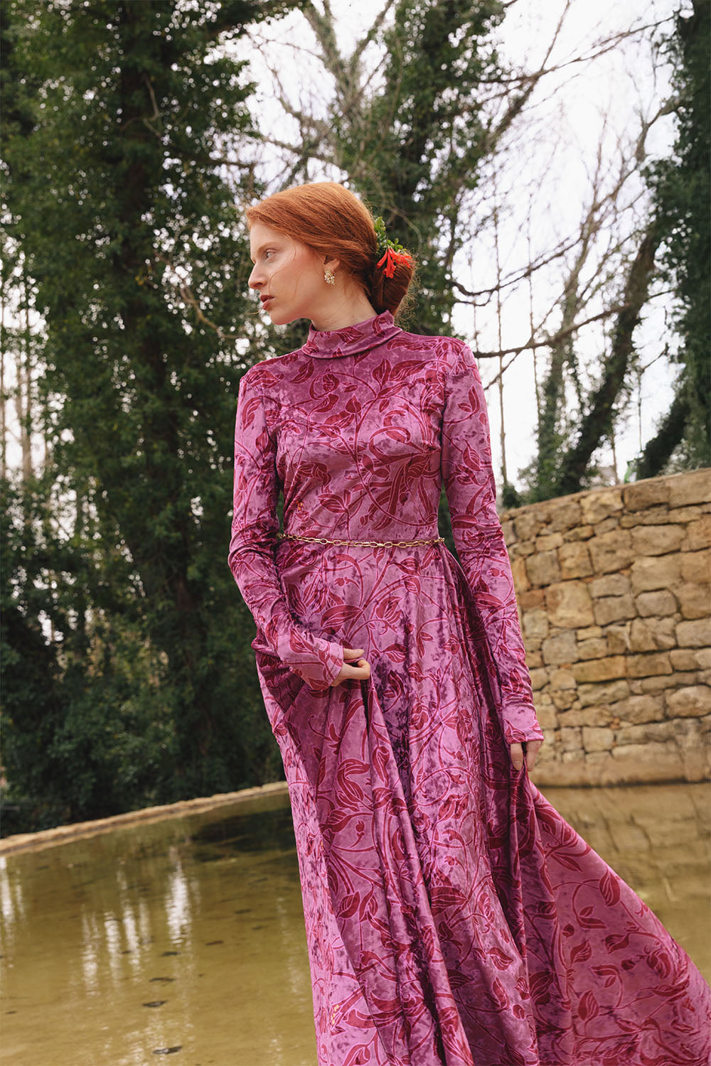 Velvet floral print dress with high neck worn by a model.