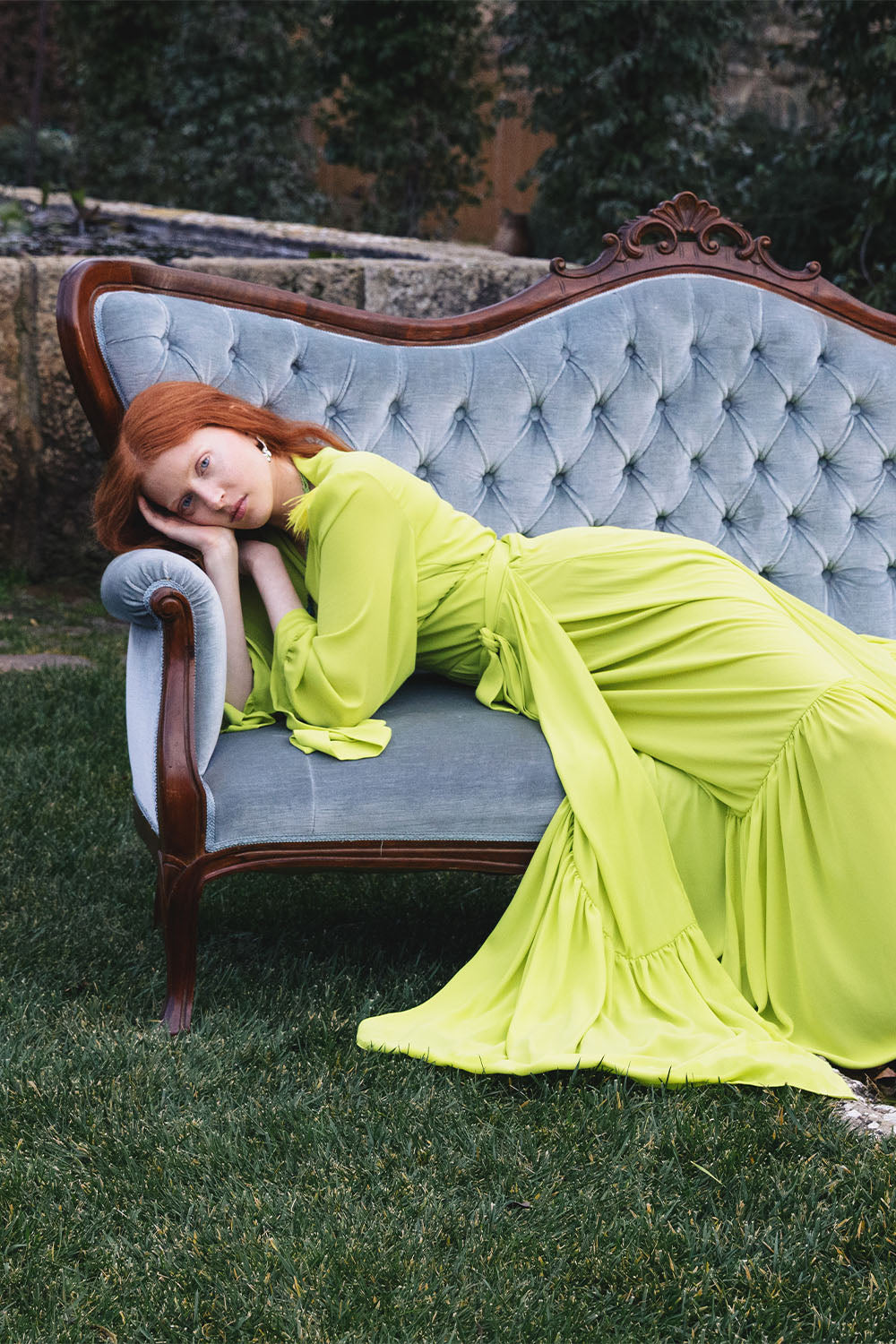 Lime green maxi dress with feather-trimmed shoulders worn by a model.