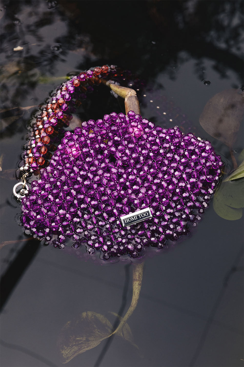 Purple beaded shoulder bag with multicolor beaded strap.