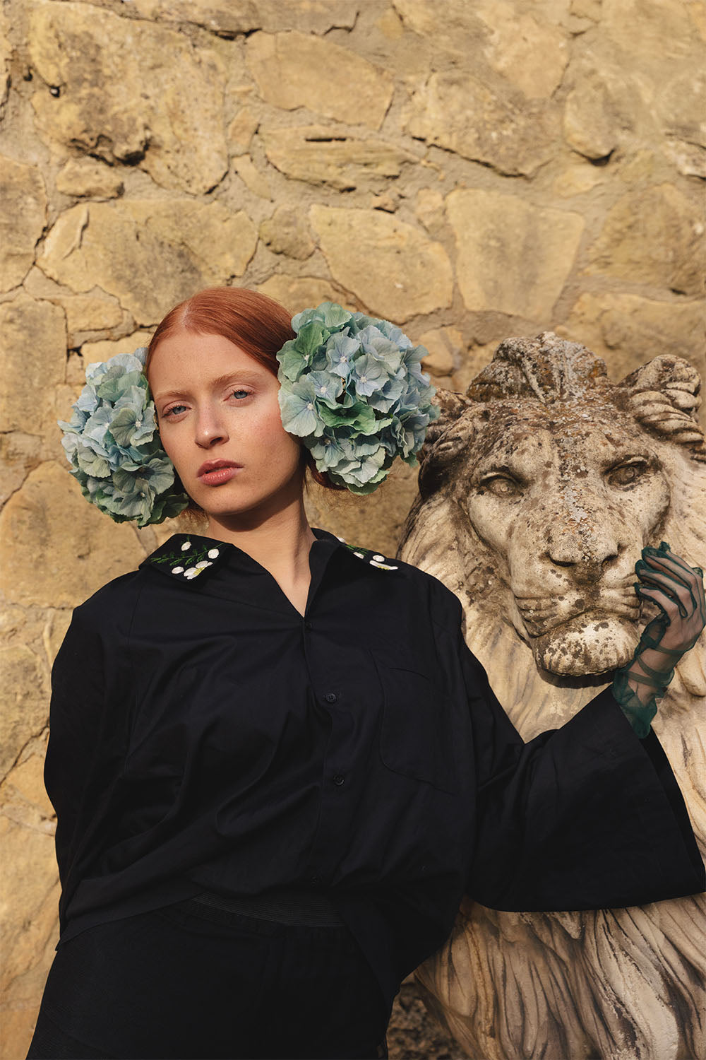 Black shirt with floral embroidered collar worn by a model.