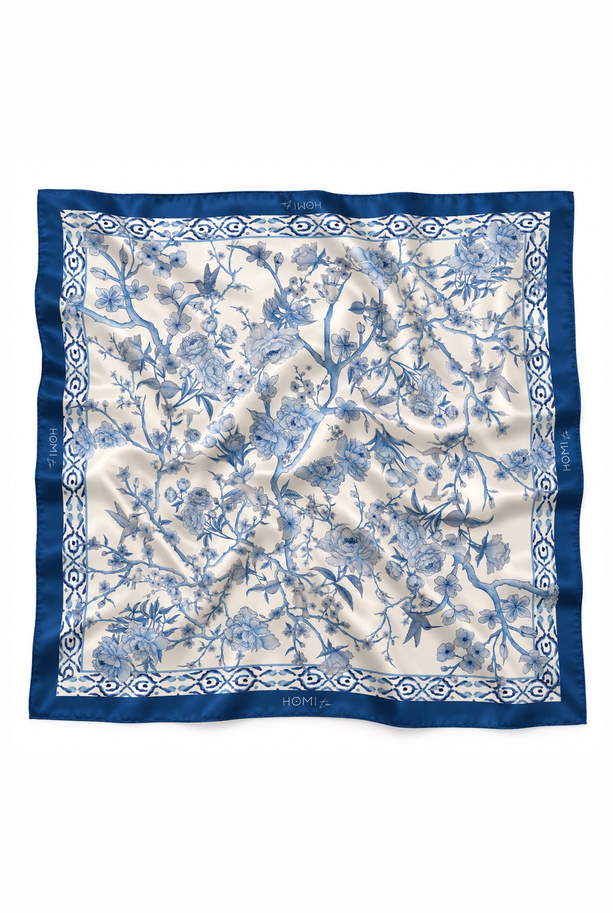 Blue and white floral silk scarf with a deep blue border and intricate botanical pattern featuring flowers, branches and leaves.