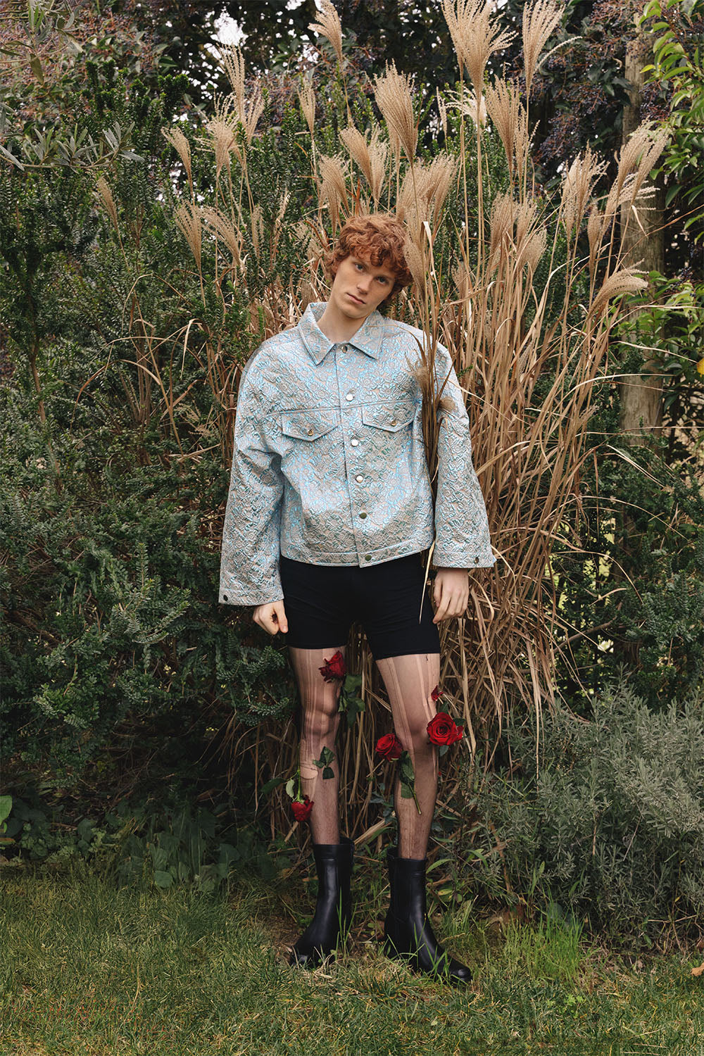 Oversized blue and silver brocade jacket worn by a model.