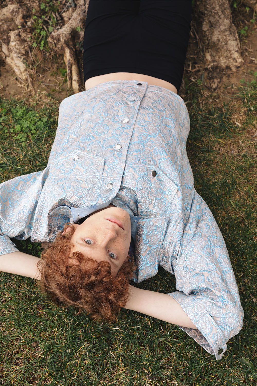 Oversized blue and silver brocade jacket worn by a model.