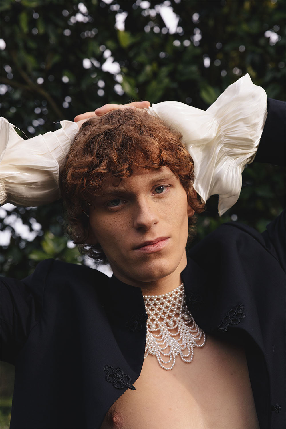 Black jacket with embroidered details worn by a model.