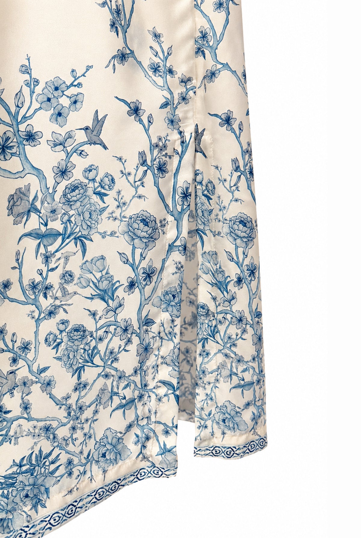Close-up of the blue floral details on the ivory skirt.