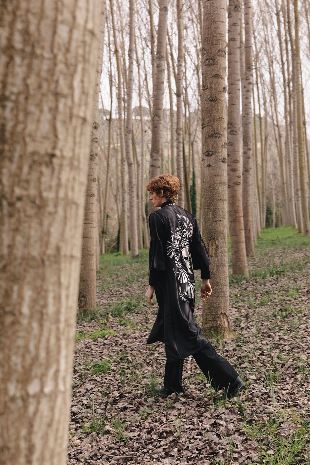 Black wide-leg trousers worn by a model.