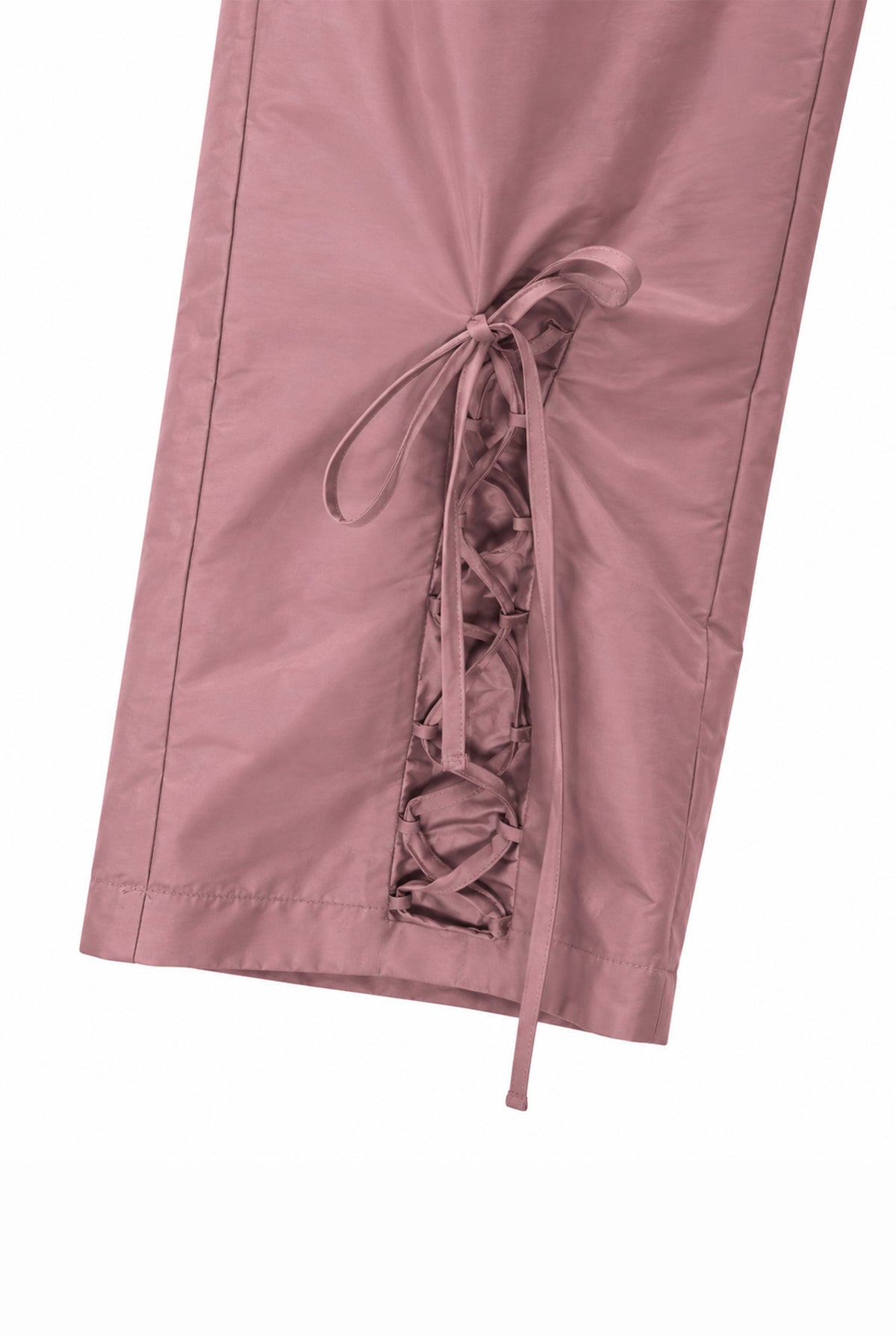 Detail of the lace-up design on the pink taffeta trousers.