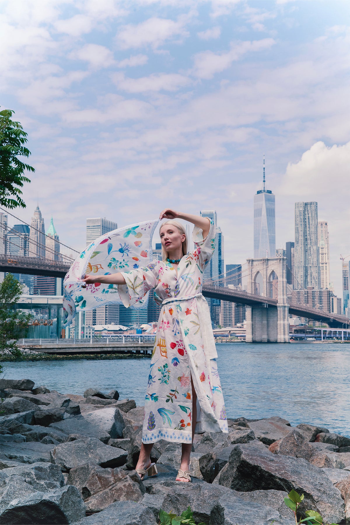 Cream kimono with colorful botanical print, wide sleeves and matching waist belt worn by a model.
