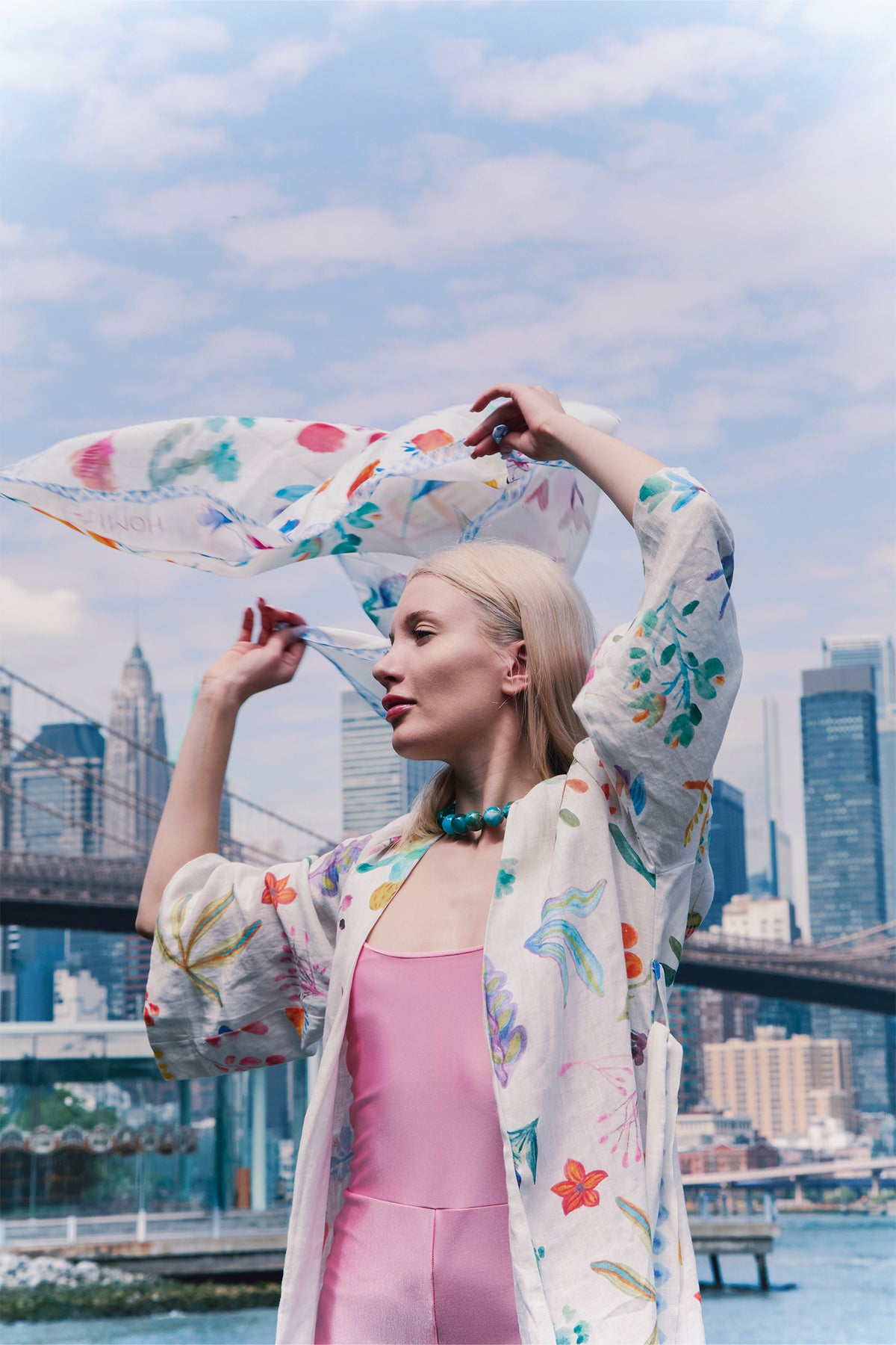 Cream kimono with colorful botanical print, wide sleeves and matching waist belt worn by a model.