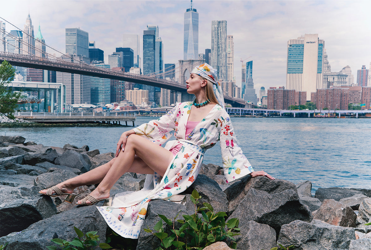 Cream kimono with colorful botanical print, wide sleeves and matching waist belt worn by a model.