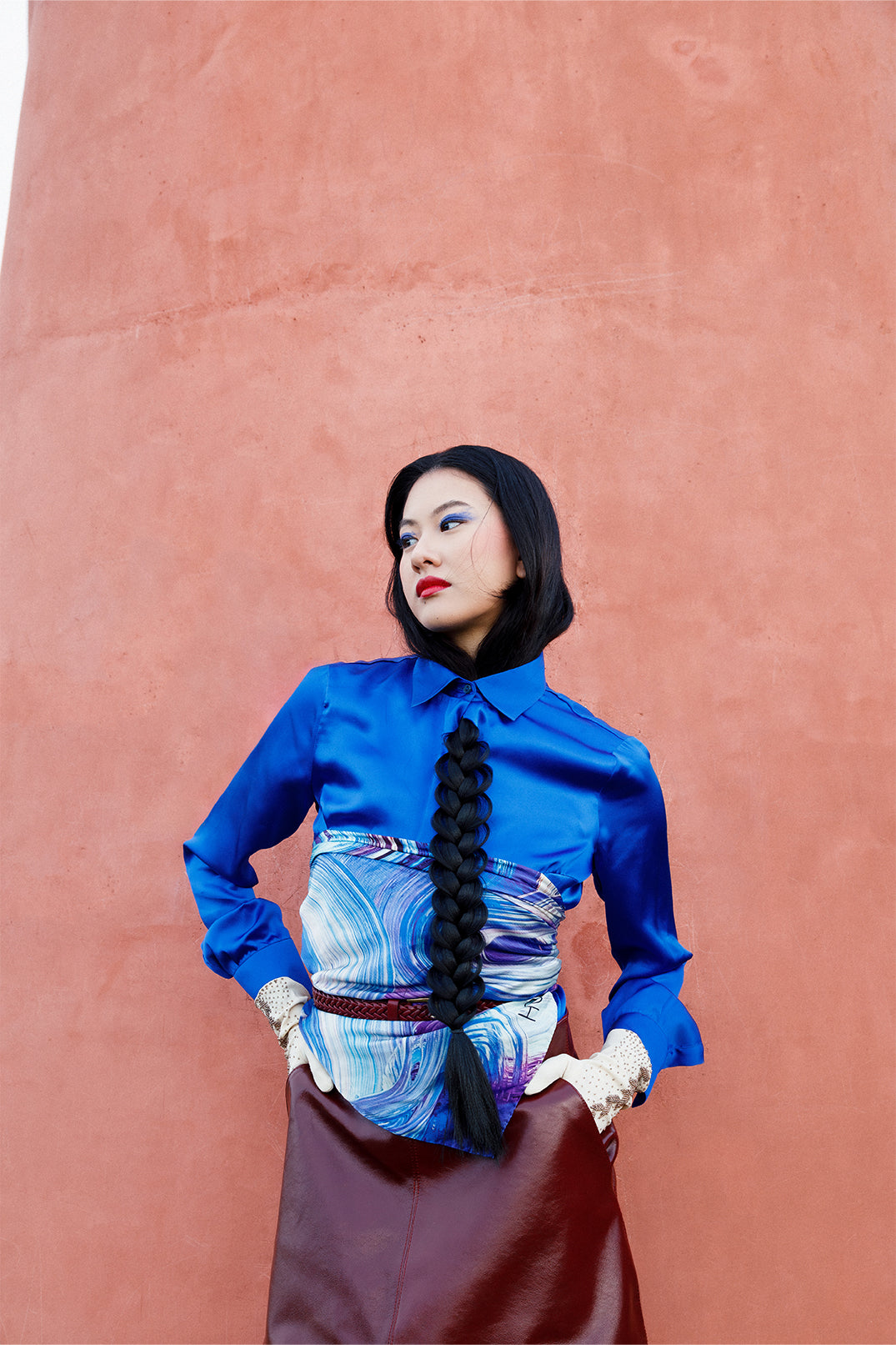 Deep blue silk shirt worn by a model, fluid and lightweight.