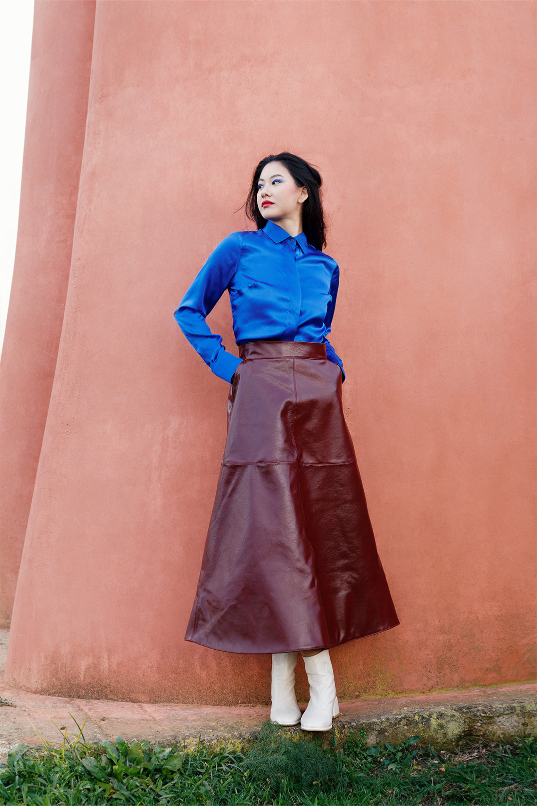 Deep blue silk shirt worn by a model, fluid and lightweight.