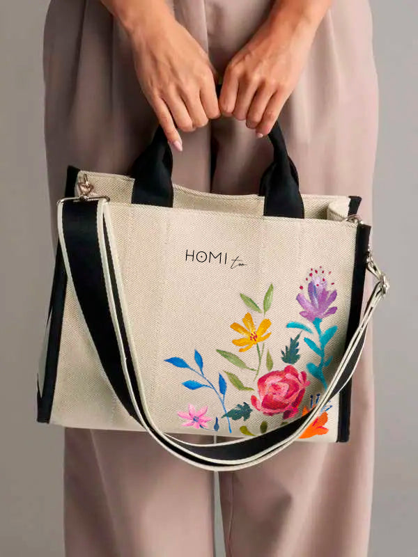 Summer canvas tote bag 33.5x26x12.5 cm, hand-painted with delicate floral motifs, featuring a minimal design, gold-tone metal finishes, comfortable handles, and a contrasting adjustable shoulder strap.