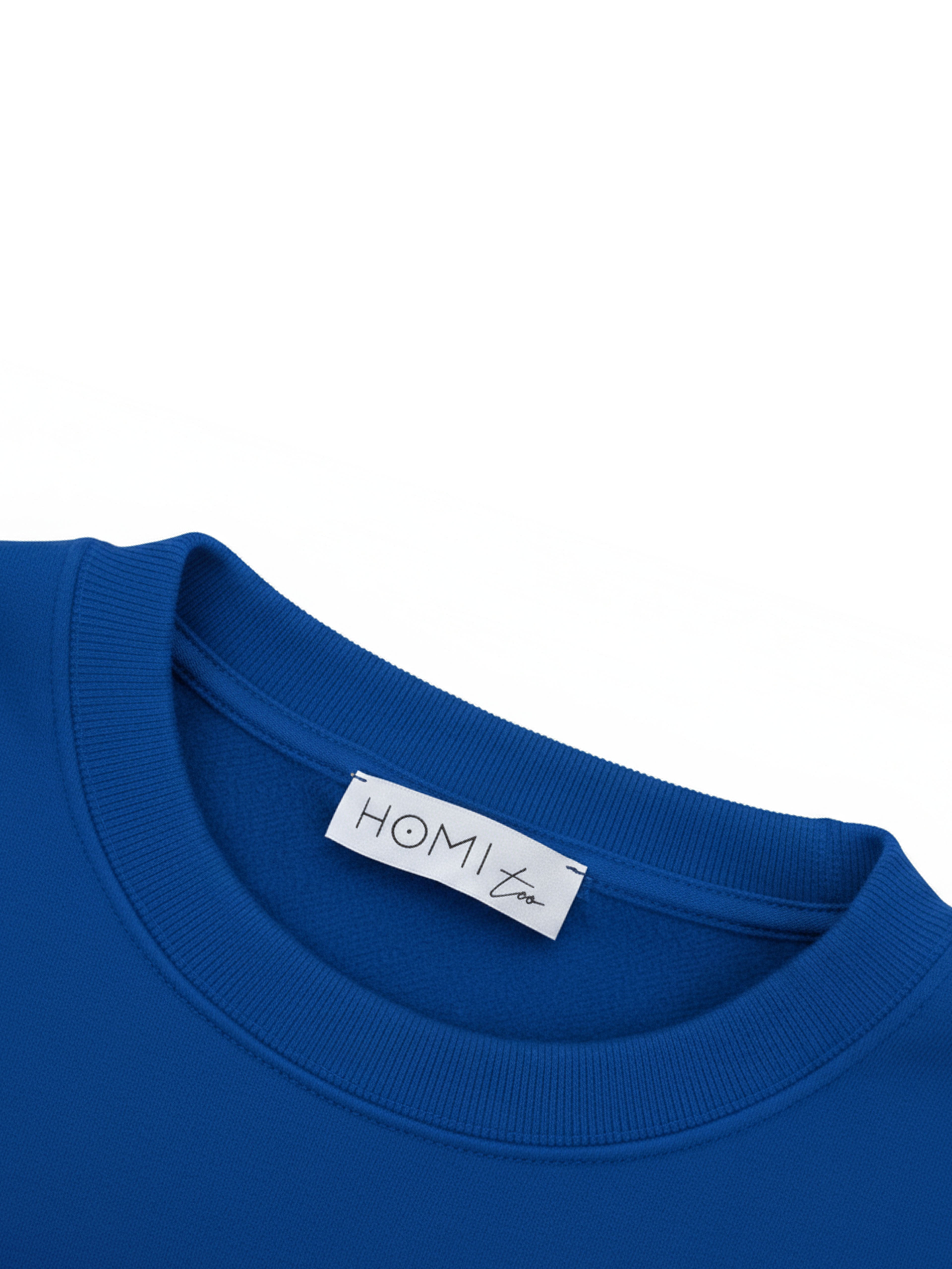 Close-up of the HOMI TOO logo label sewn on the back neckline of the sweatshirt.