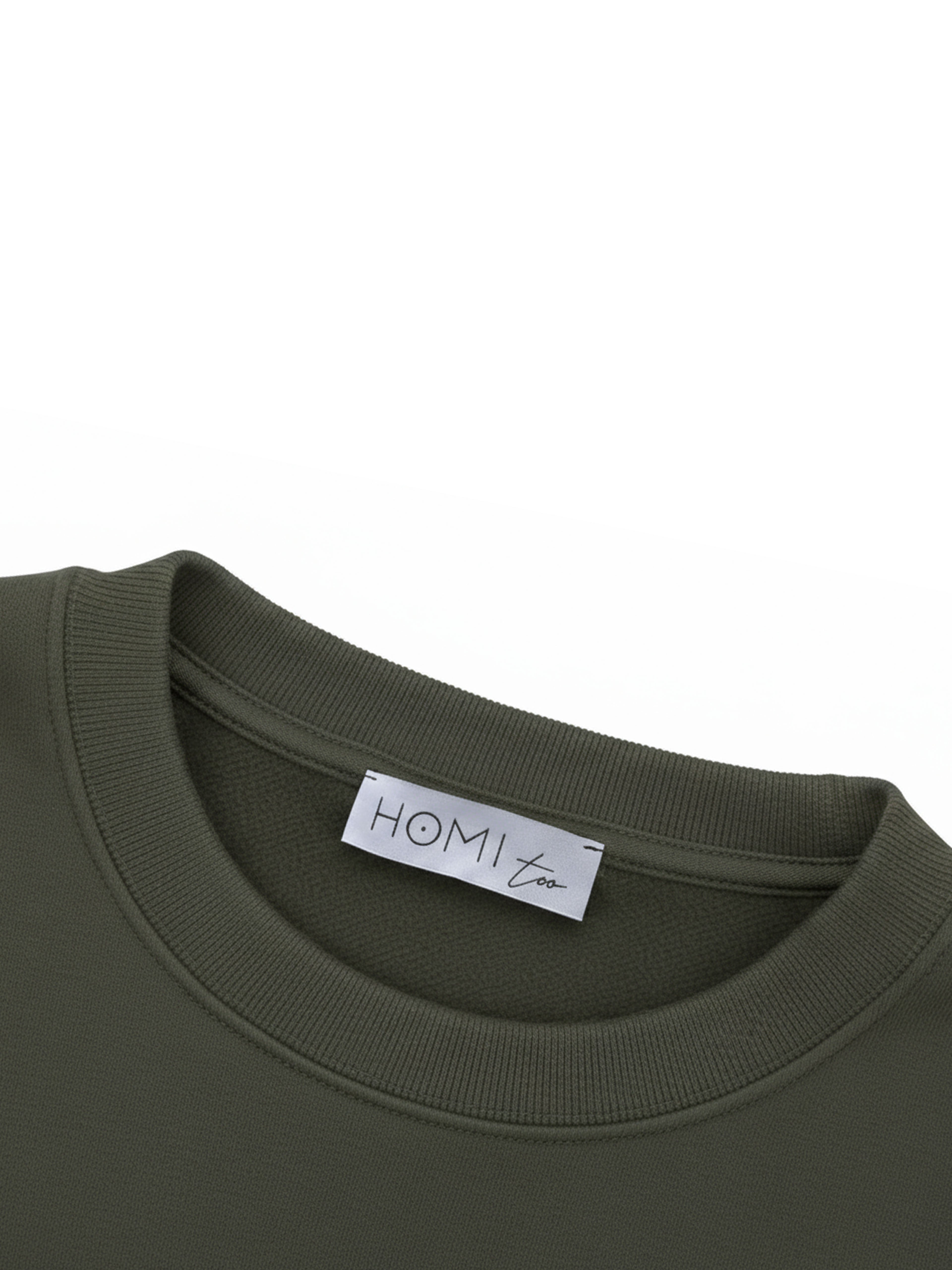 Close-up of the HOMI TOO logo label sewn on the back neckline of the sweatshirt.
