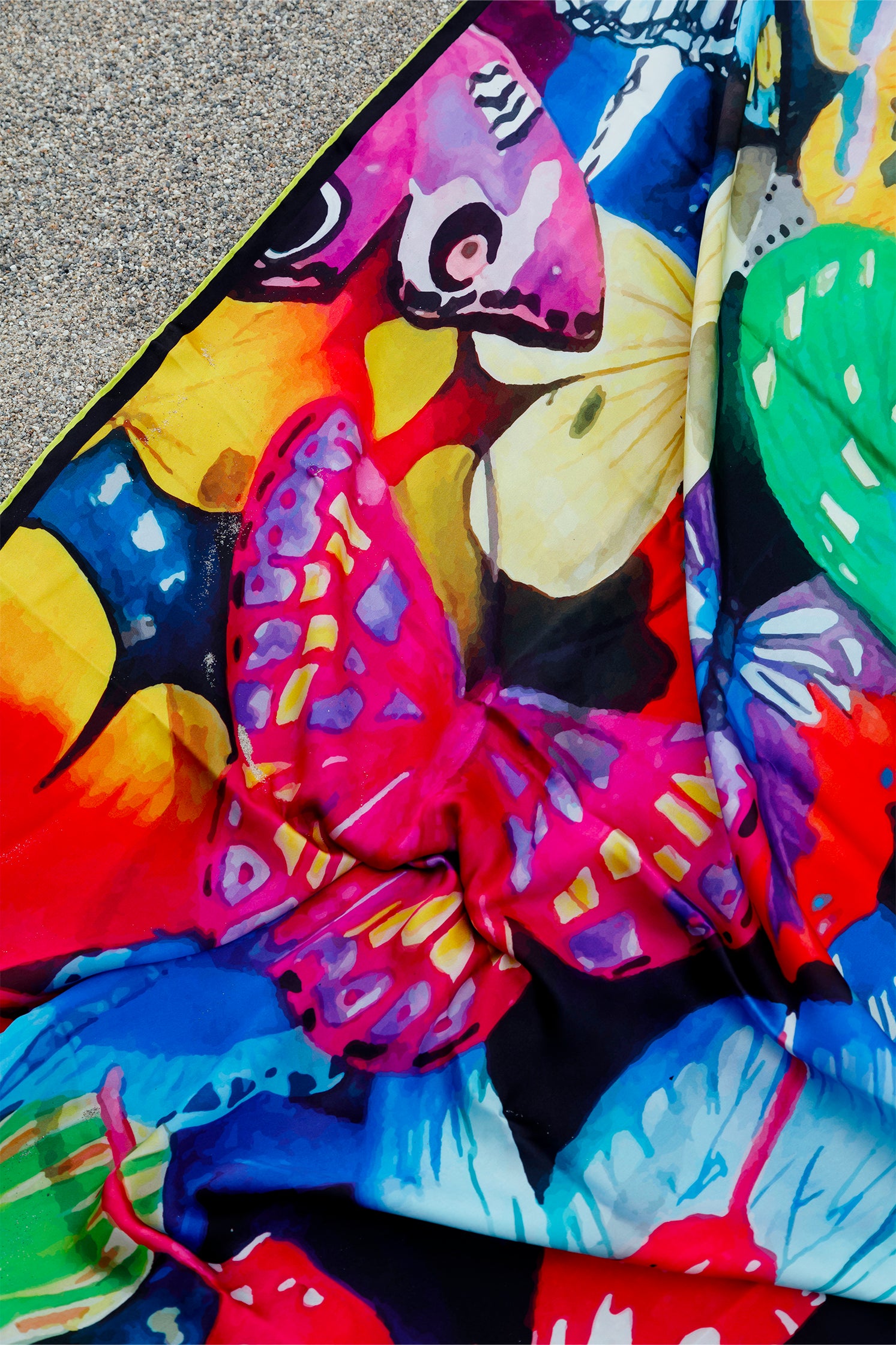 Close-up of the butterfly print on the pure silk scarf, with painterly brushstrokes and vibrant artistic details.