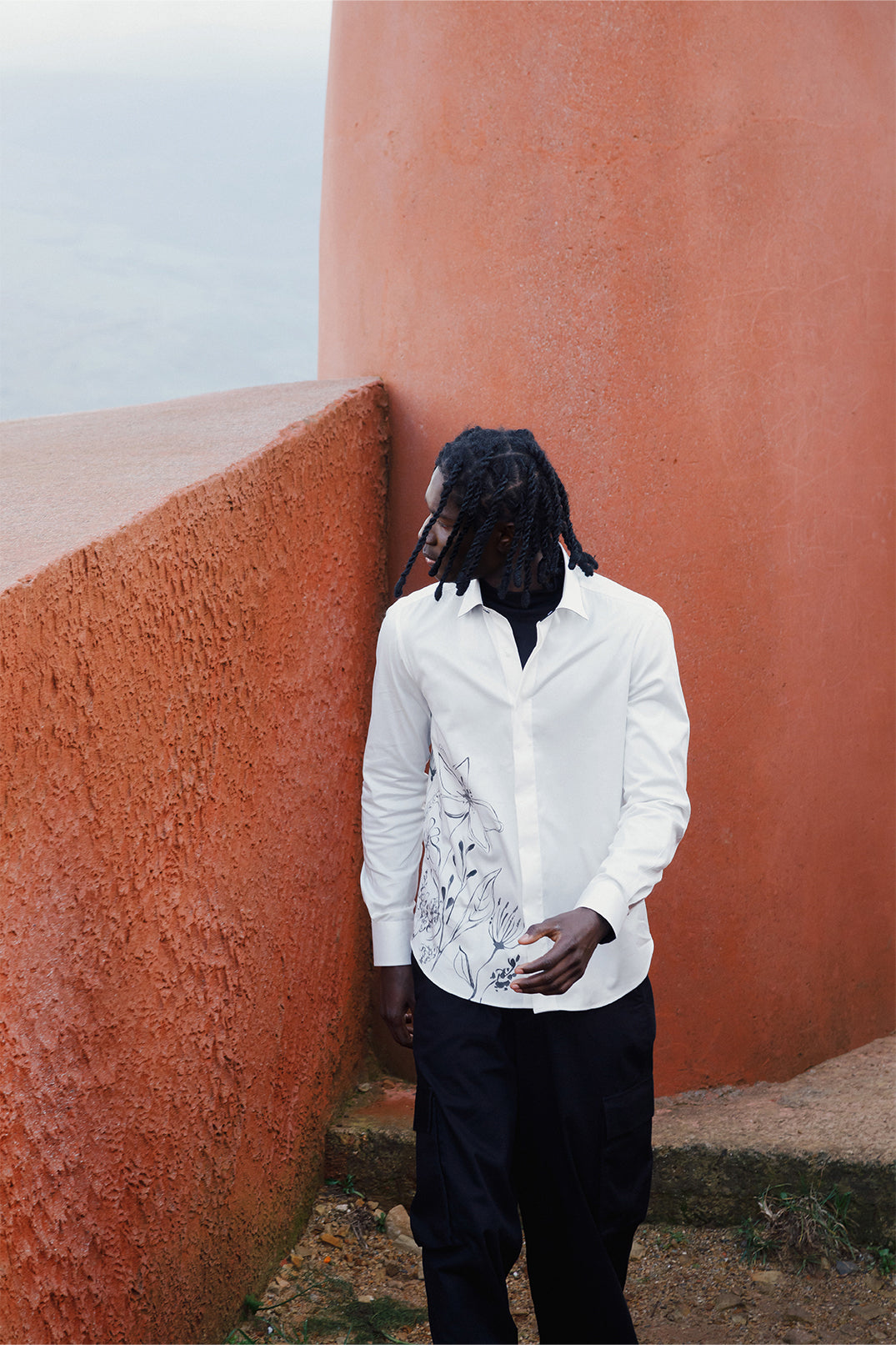 White cotton shirt hand-painted with original brushstrokes applied directly on the fabric, worn by a model.