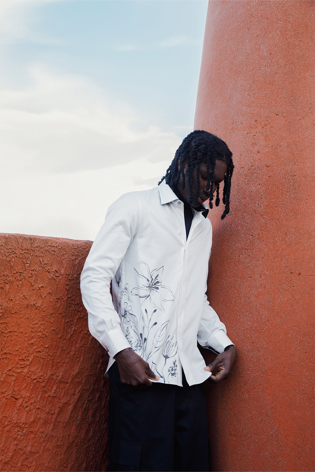 White cotton shirt hand-painted with original brushstrokes applied directly on the fabric, worn by a model.