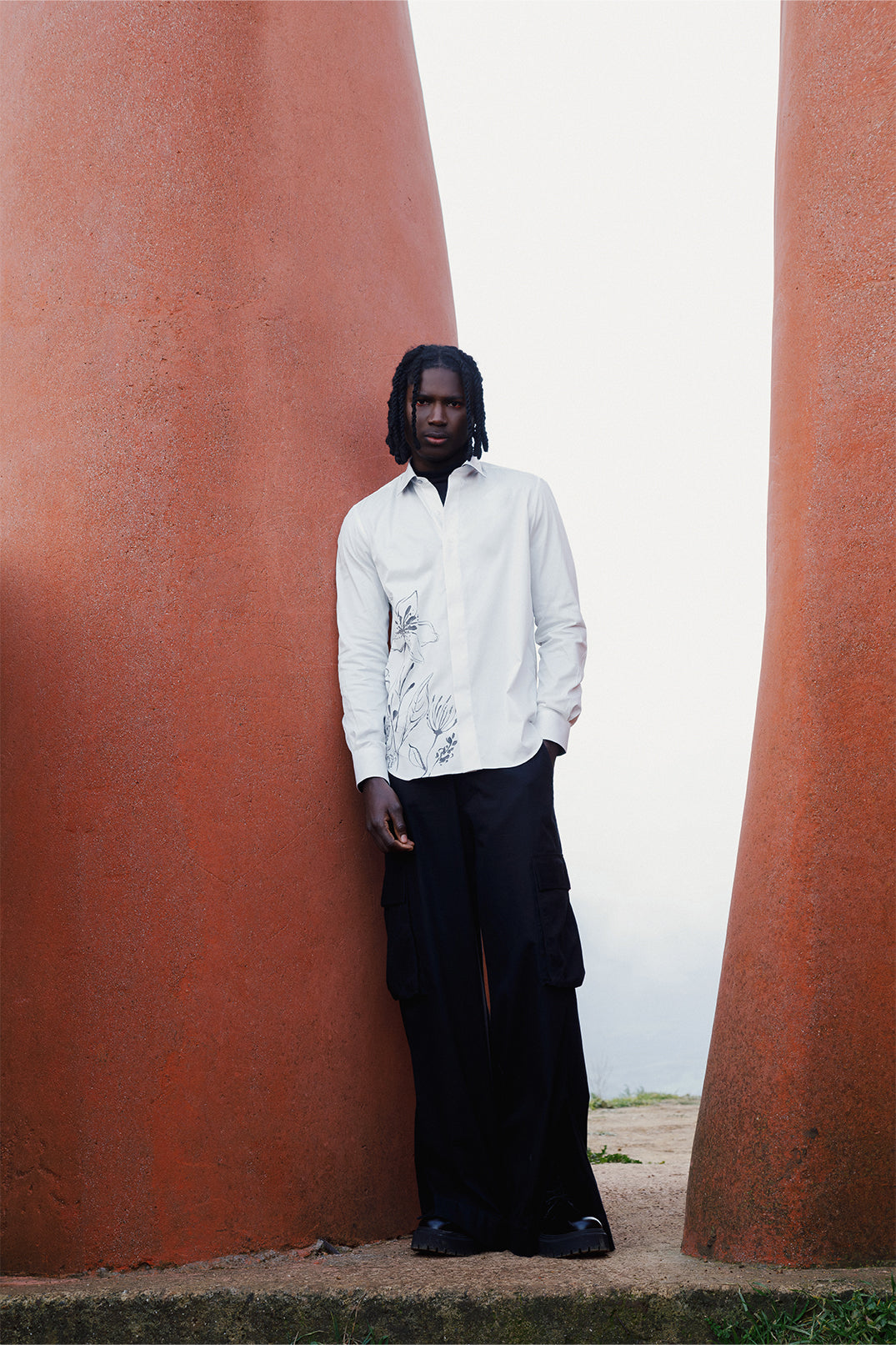 White cotton shirt hand-painted with original brushstrokes applied directly on the fabric, worn by a model.