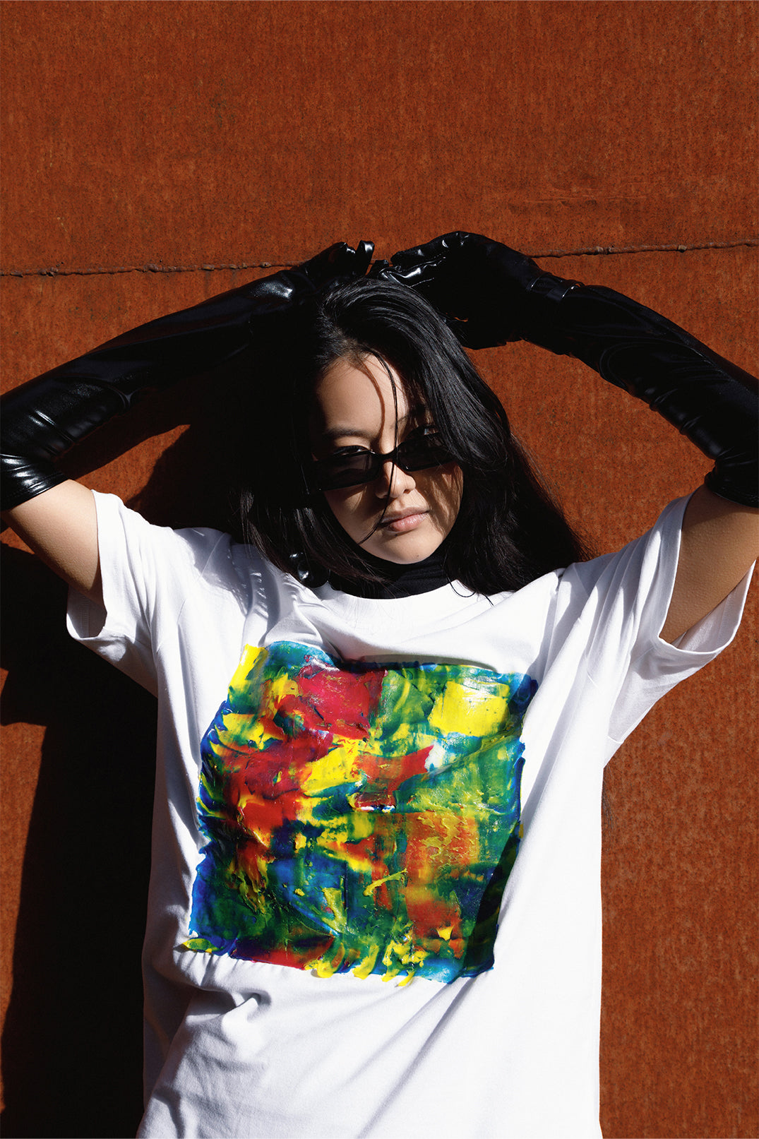 White unisex oversized T-shirt worn by a model, with central multicolor square hand-made using an exclusive silicone technique.