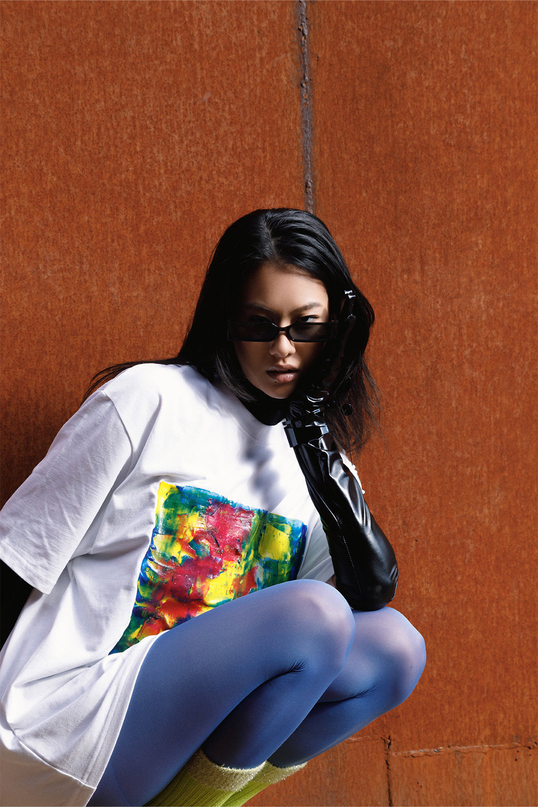 White unisex oversized T-shirt worn by a model, with central multicolor square hand-made using an exclusive silicone technique.