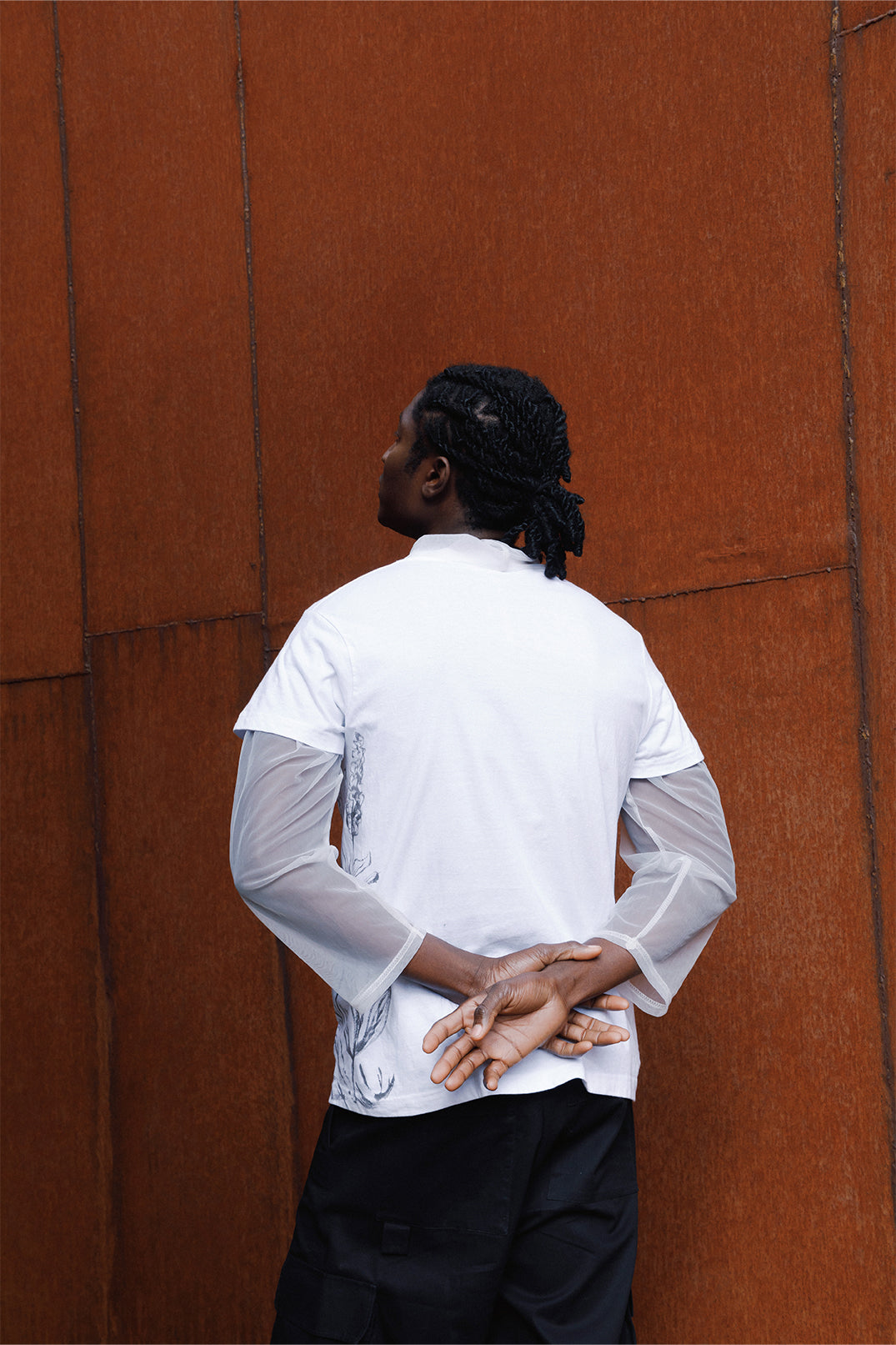 Back view of the white unisex oversized T-shirt worn by a model.