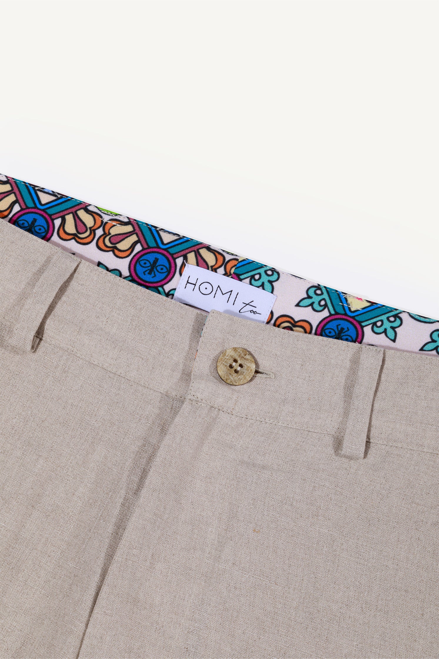 Close-up of the inner border pattern of the beige linen cargo bermuda shorts, showing original design, texture and craftsmanship