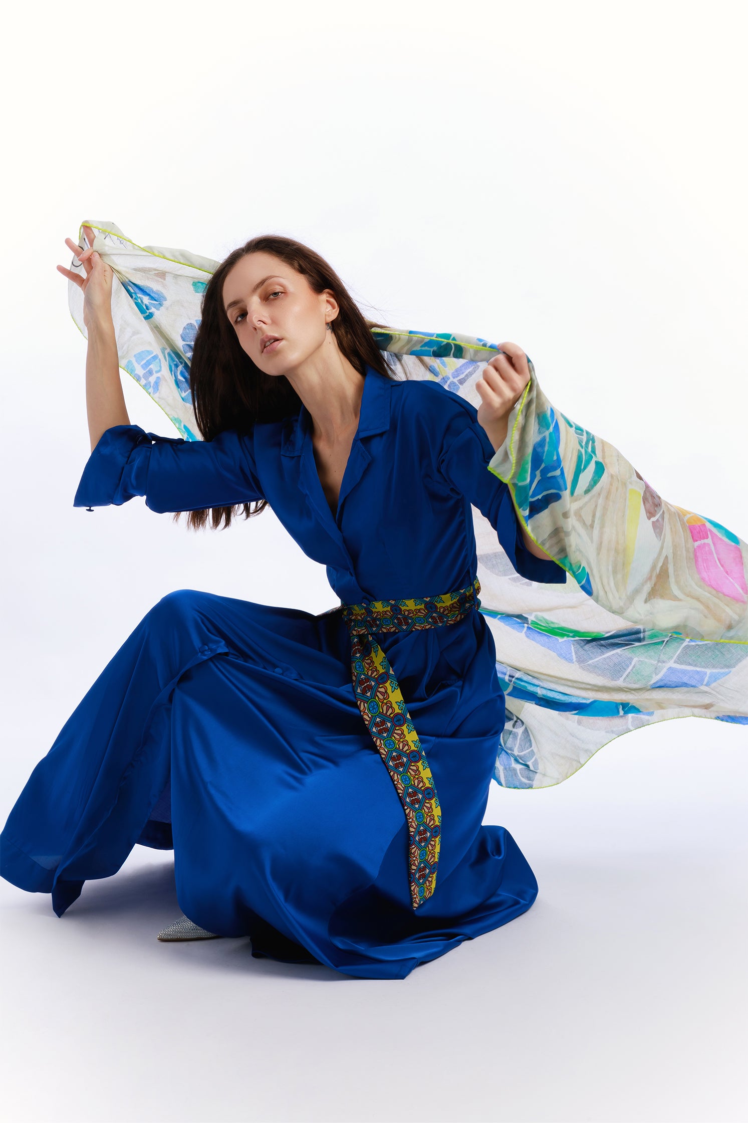 Large 140x140 cm scarf in modal and cashmere, featuring a refined print inspired by colorful stained glass windows, soft, enveloping, and elegant held by a model.