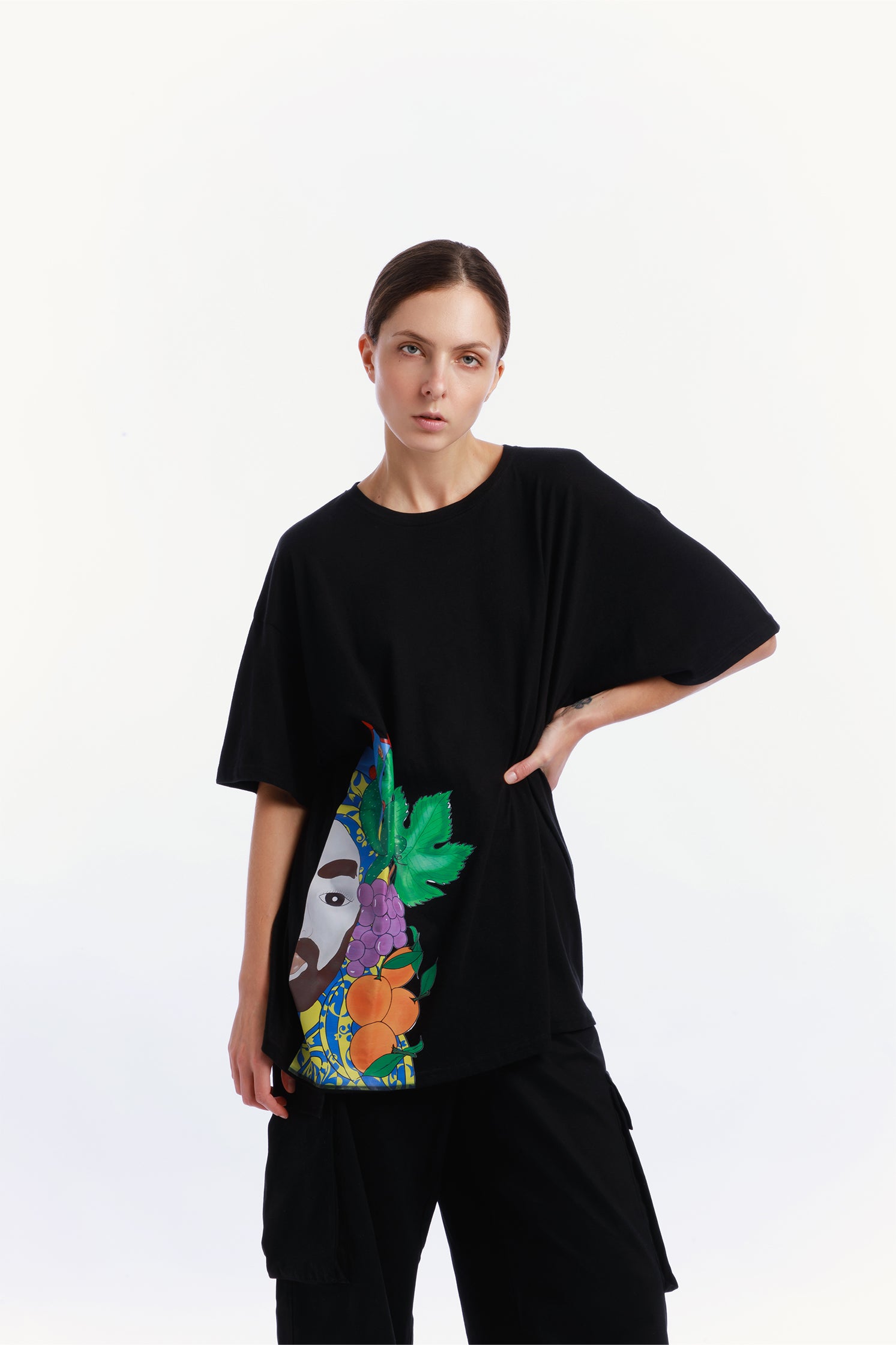 Black oversized unisex T-shirt made of 100% high-quality cotton, worn by a model, featuring a modern cut and a unique hand-painted "Testa di Moro" graphic on the right side.